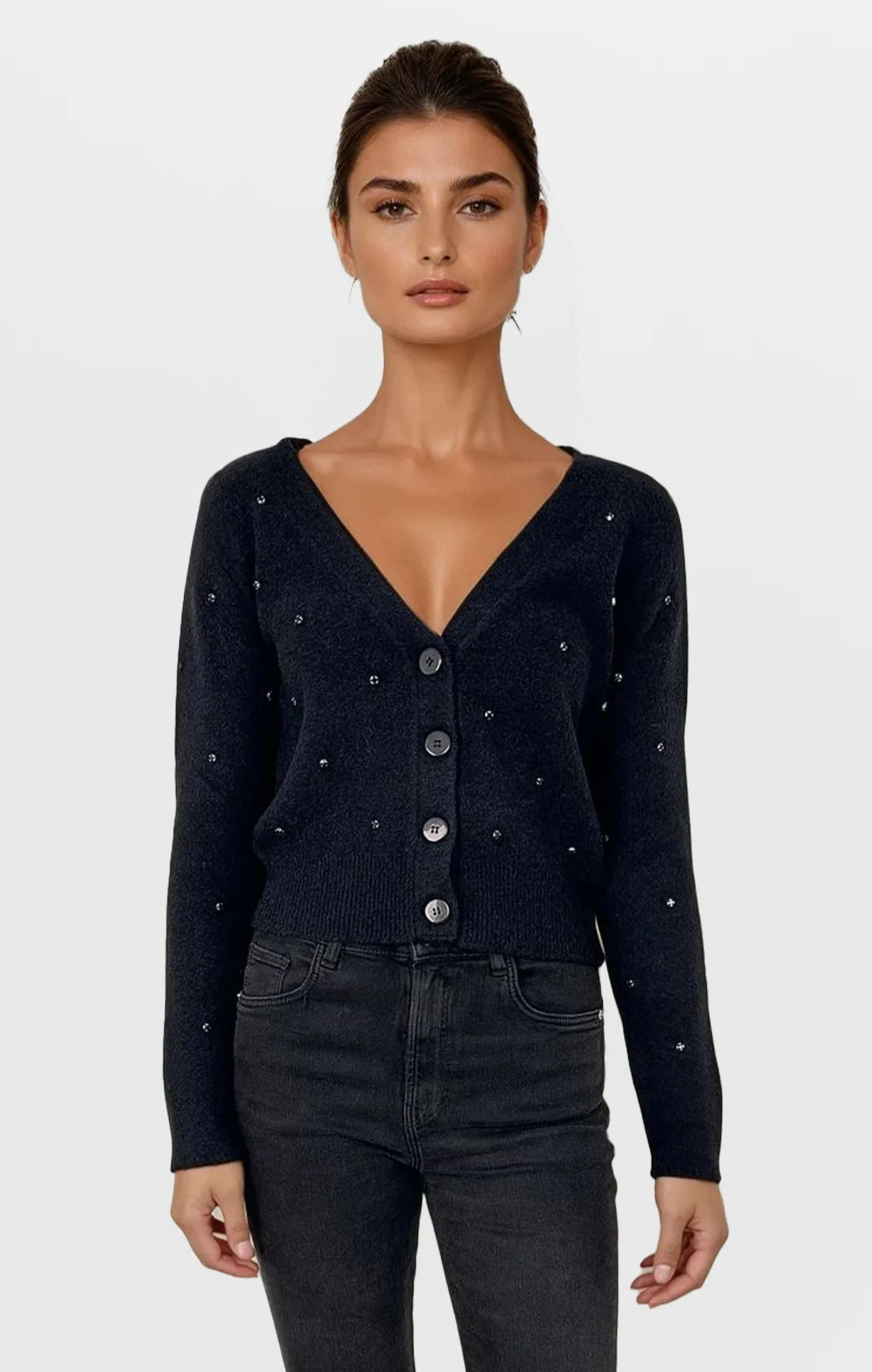 Woman wearing a black cardigan with button details on a white background