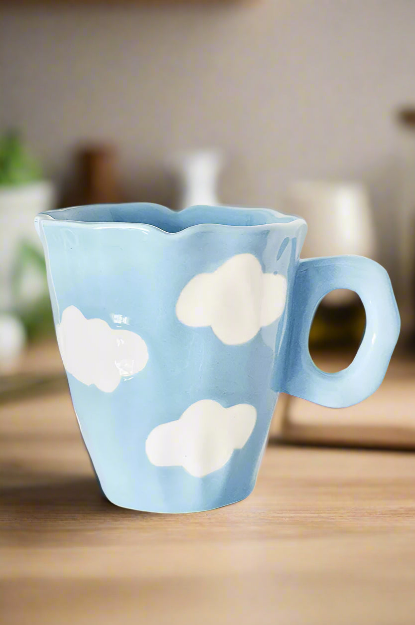 Blue mug with cloud designs on a white background