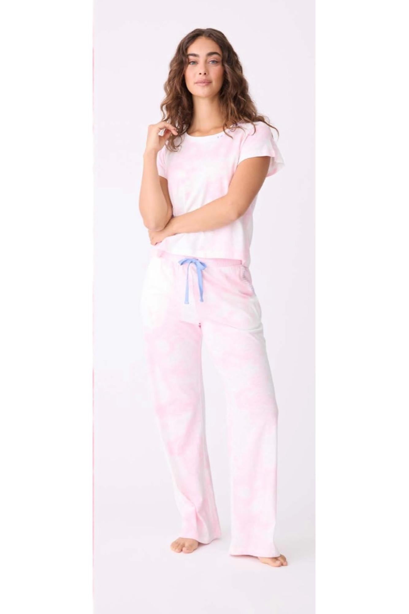 Woman wearing a pink pajama set with a white background