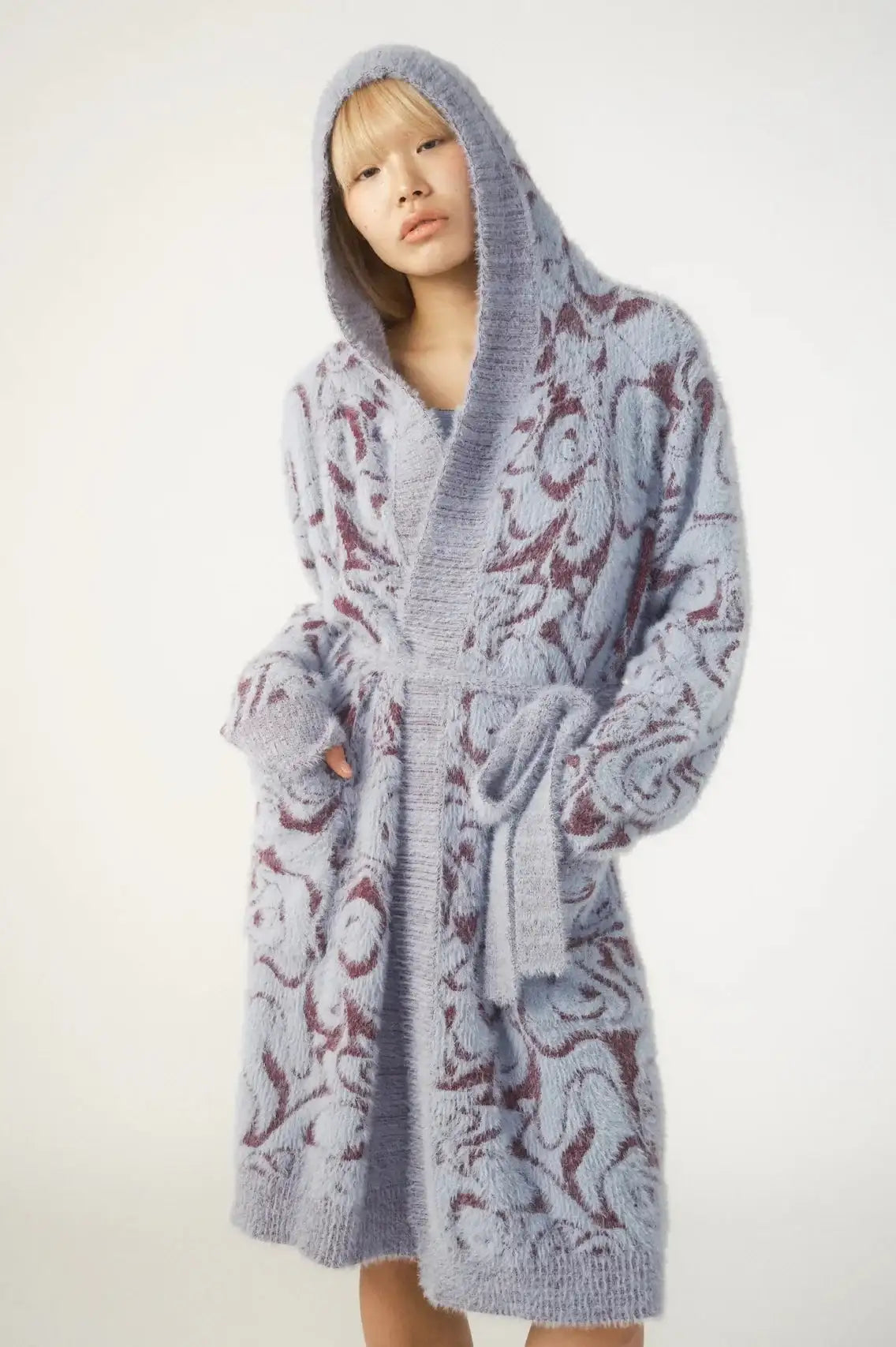 Person wearing a patterned robe on a white background