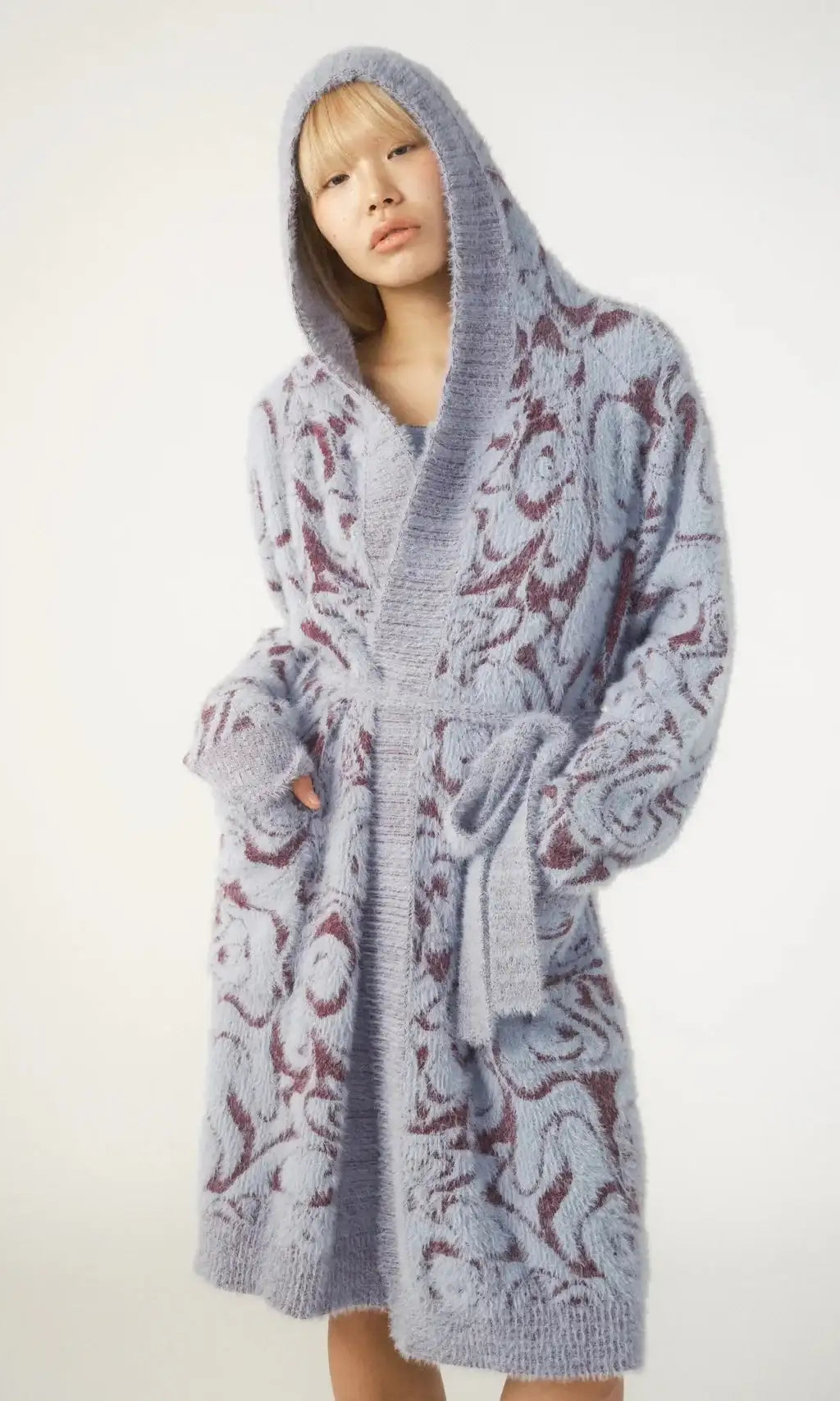 Person wearing a patterned robe on a white background