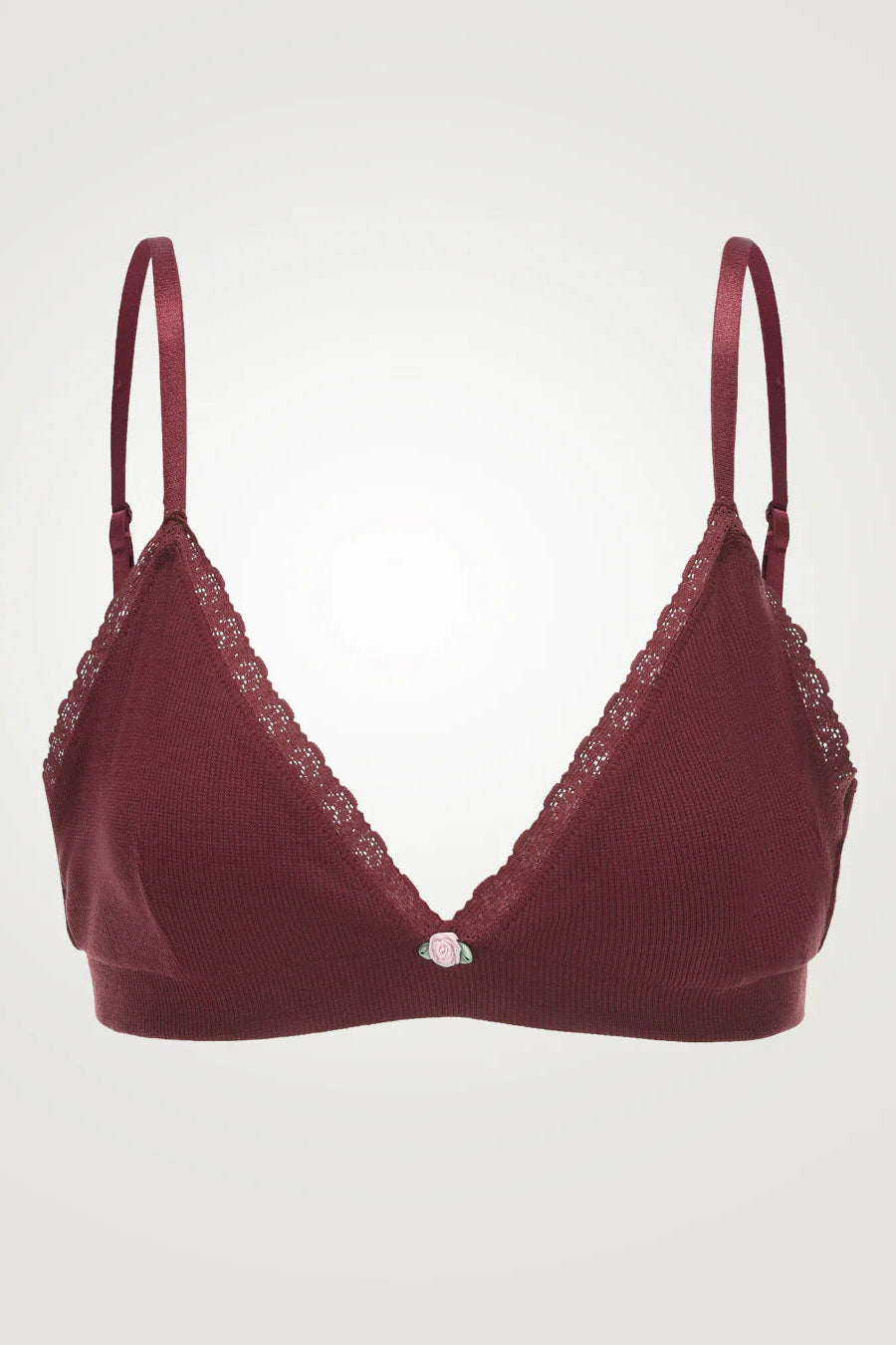Red bra with lace details on a light gray background