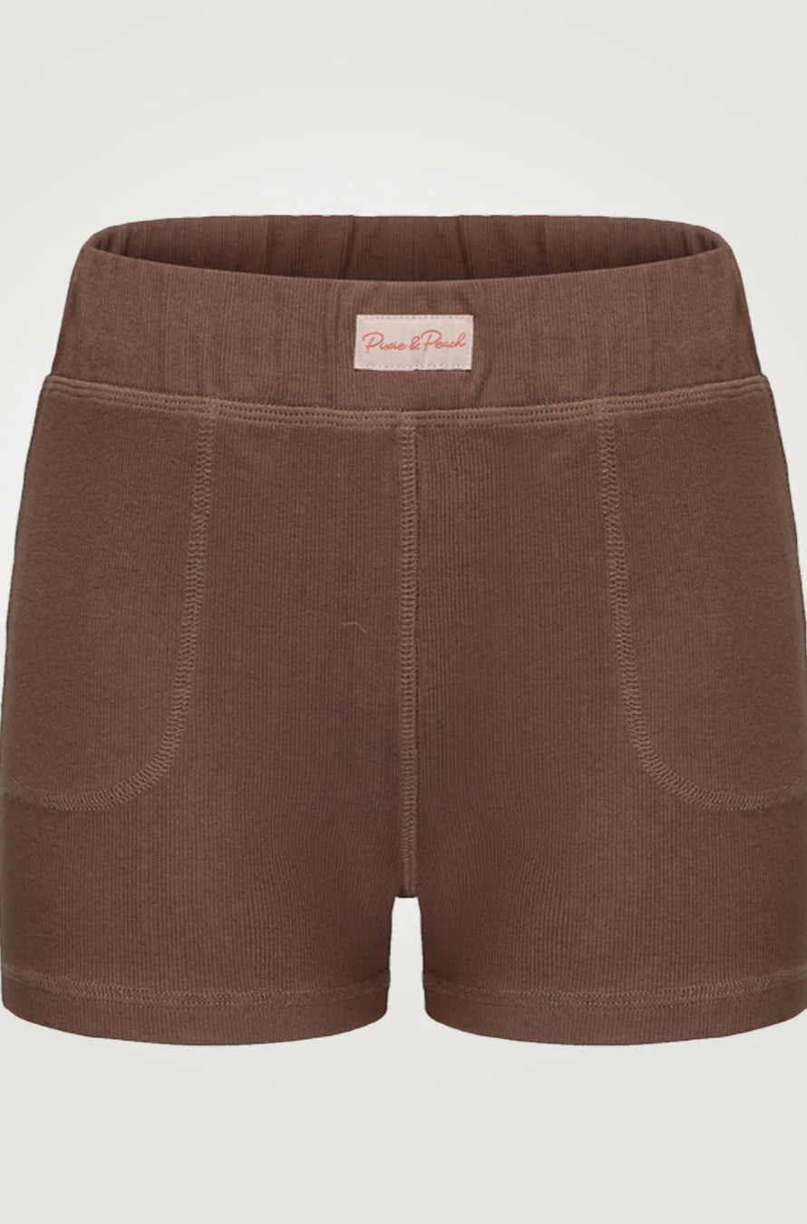 Brown shorts with a visible brand label on a light gray background