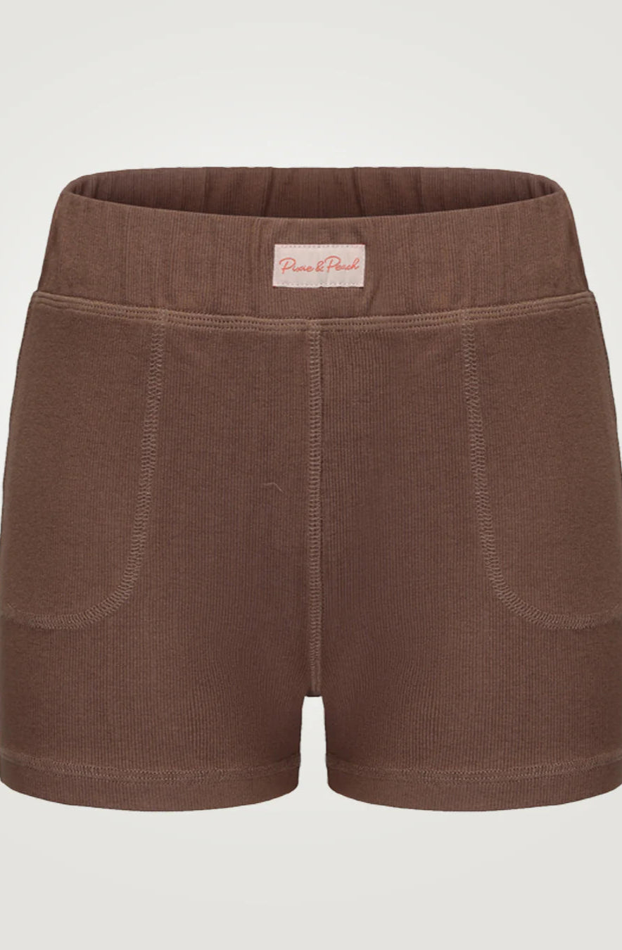 Brown shorts with a visible brand label on a light gray background