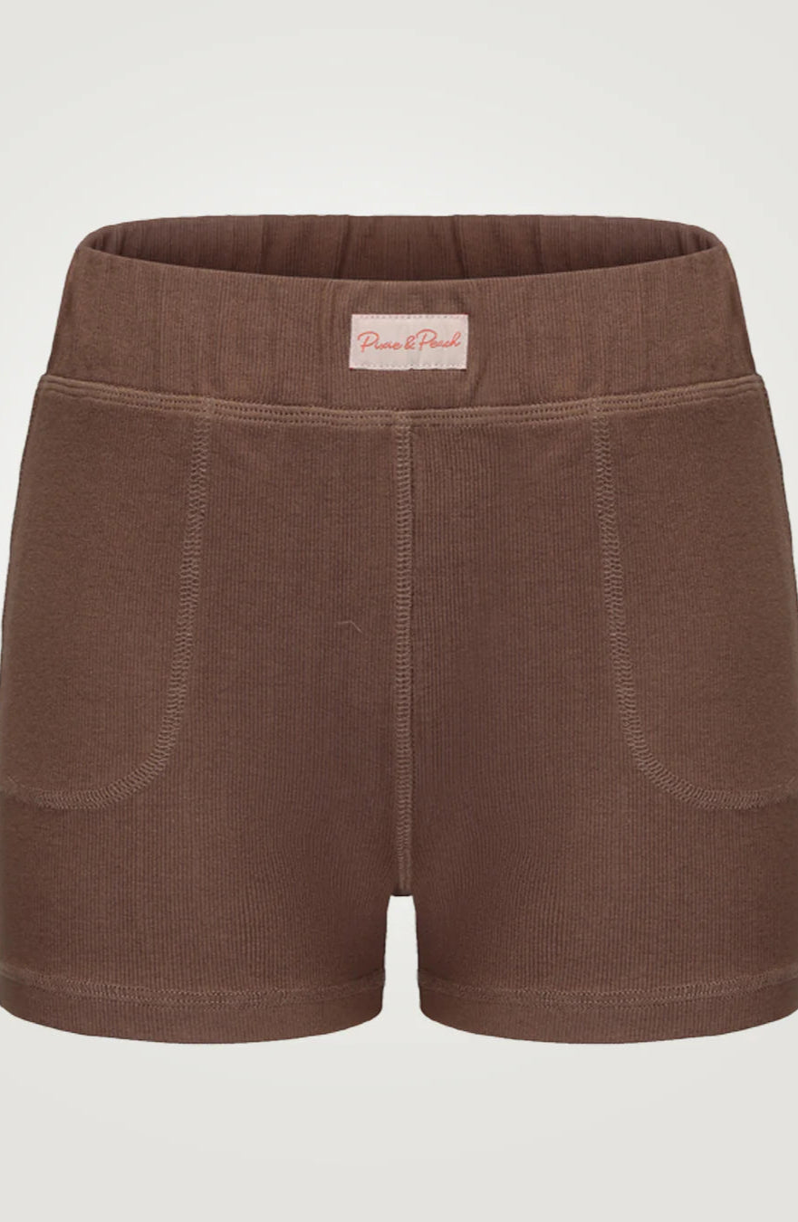 Brown shorts with a visible brand label on a light gray background