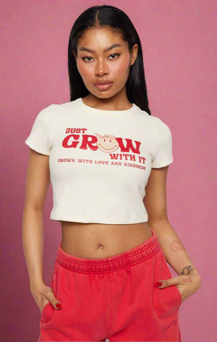 Samii Ryan x Smileyworld® Just Grow With It Baby Tee T-Shirt by Samii Ryan as seen on celebrities