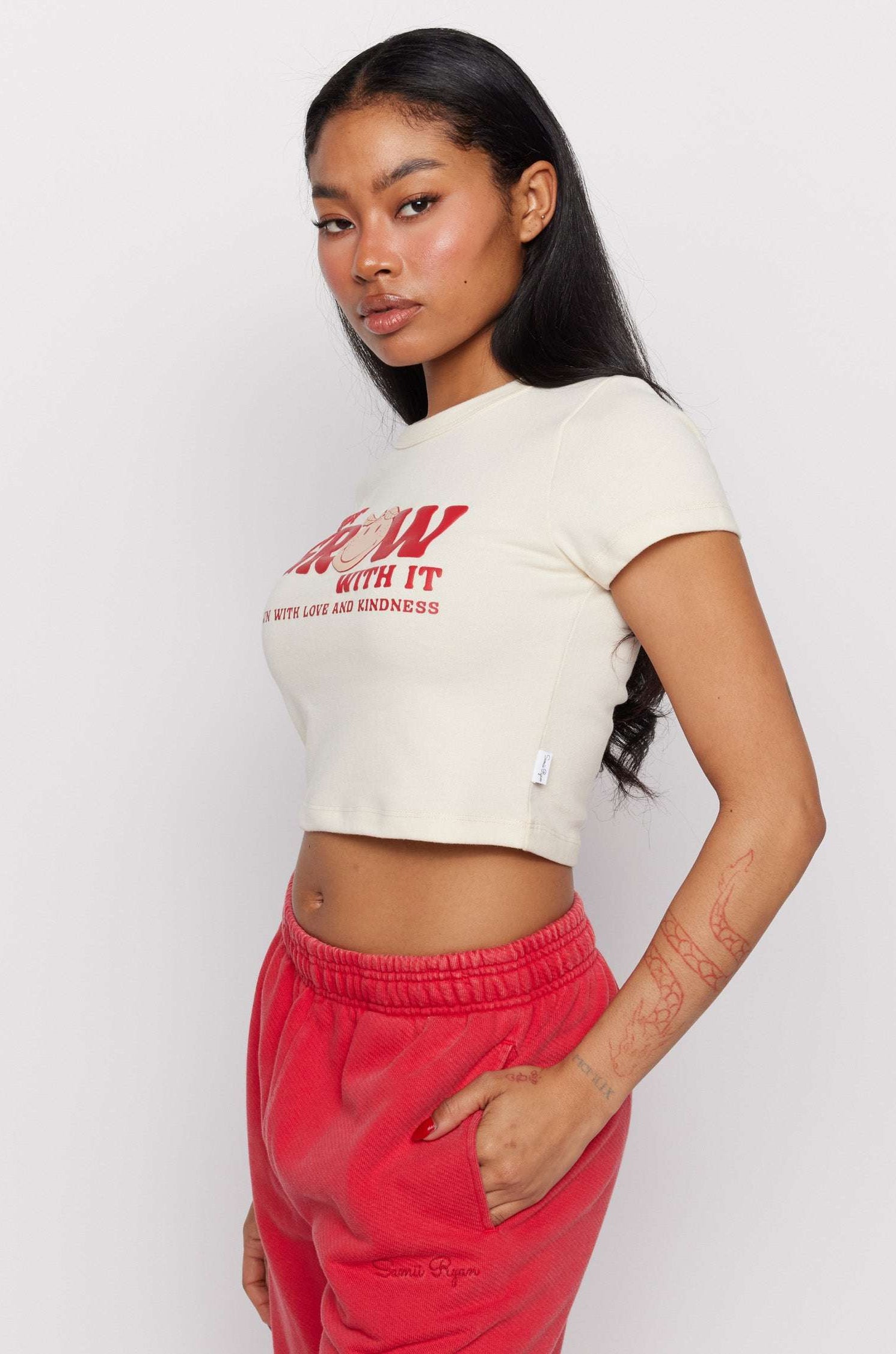 Samii Ryan x Smileyworld® Just Grow With It Baby Tee T-Shirt by Samii Ryan as seen on celebrities