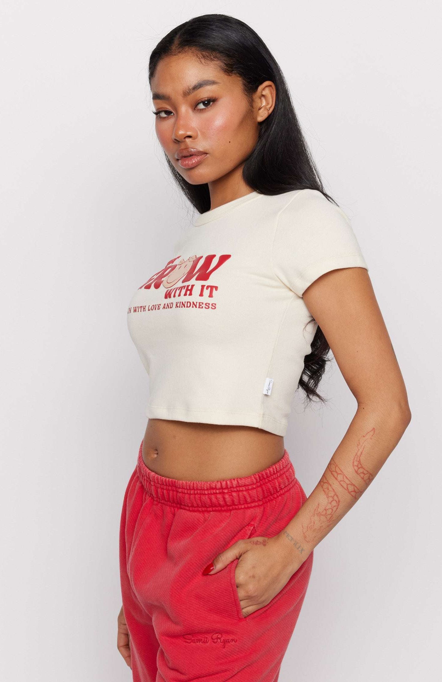 Samii Ryan x Smileyworld® Just Grow With It Baby Tee T-Shirt by Samii Ryan as seen on celebrities