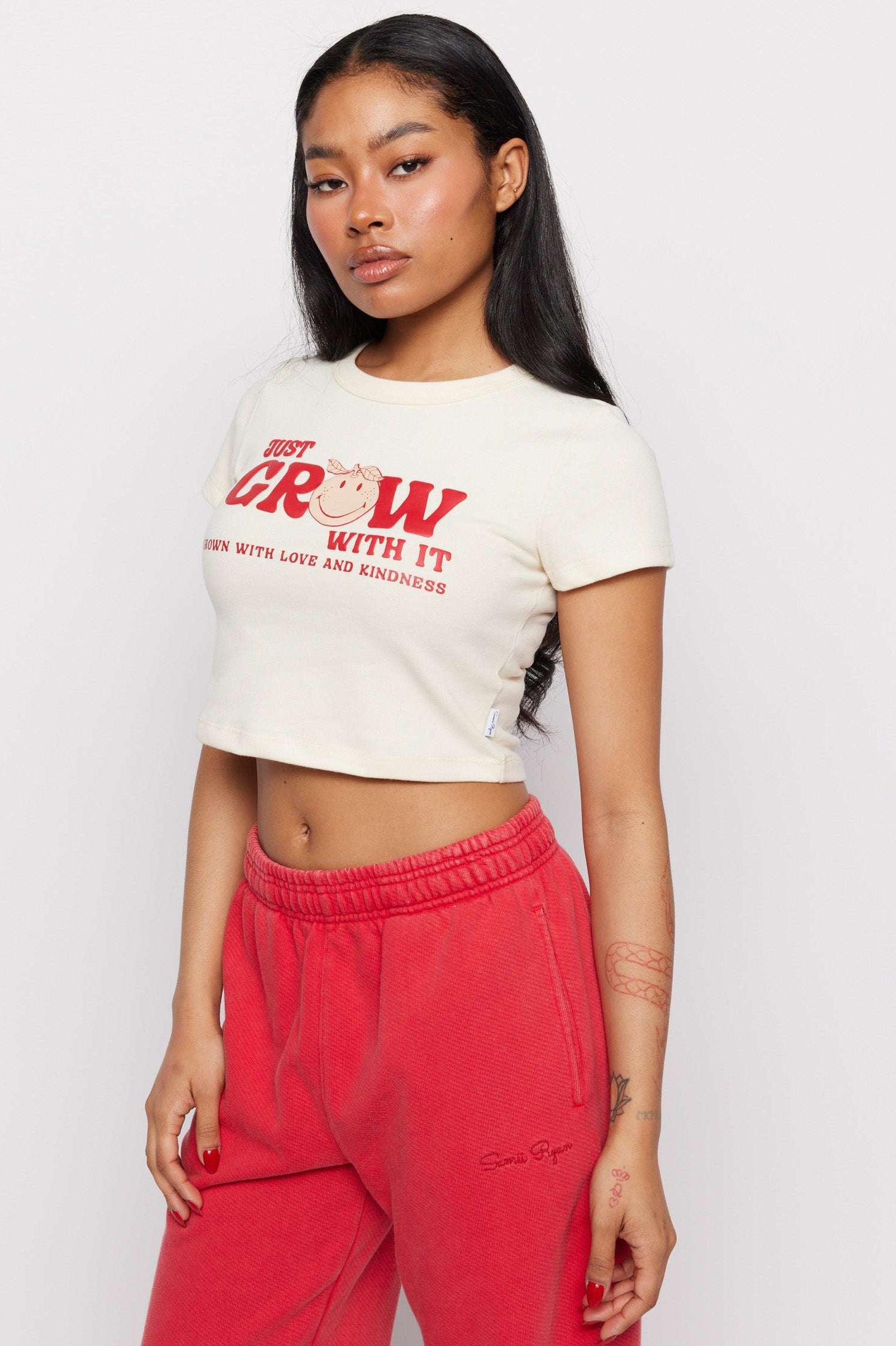Samii Ryan x Smileyworld® Just Grow With It Baby Tee T-Shirt by Samii Ryan as seen on celebrities