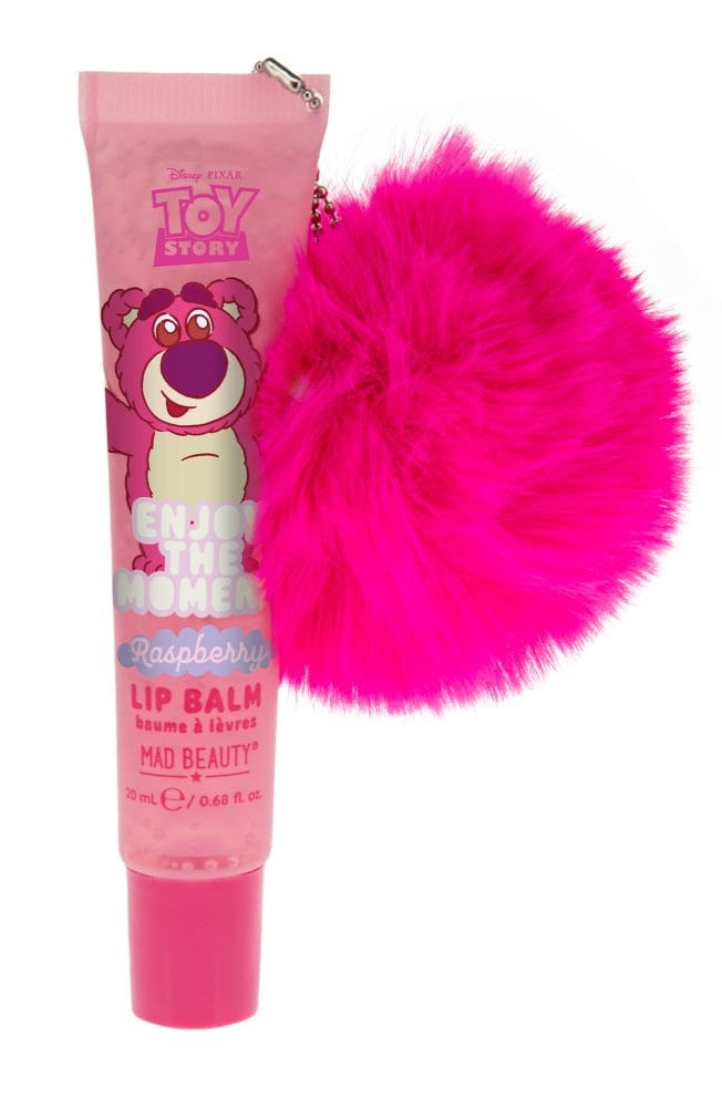 Pink lip balm with a fluffy pink accessory on a white background