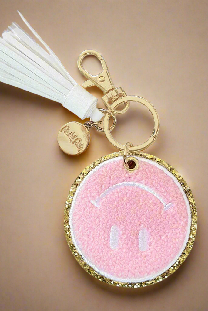 Packed Party Keep Cozy Smiley Keychain by Packed Party – Keyring – Pink | Spoiled Brat UK