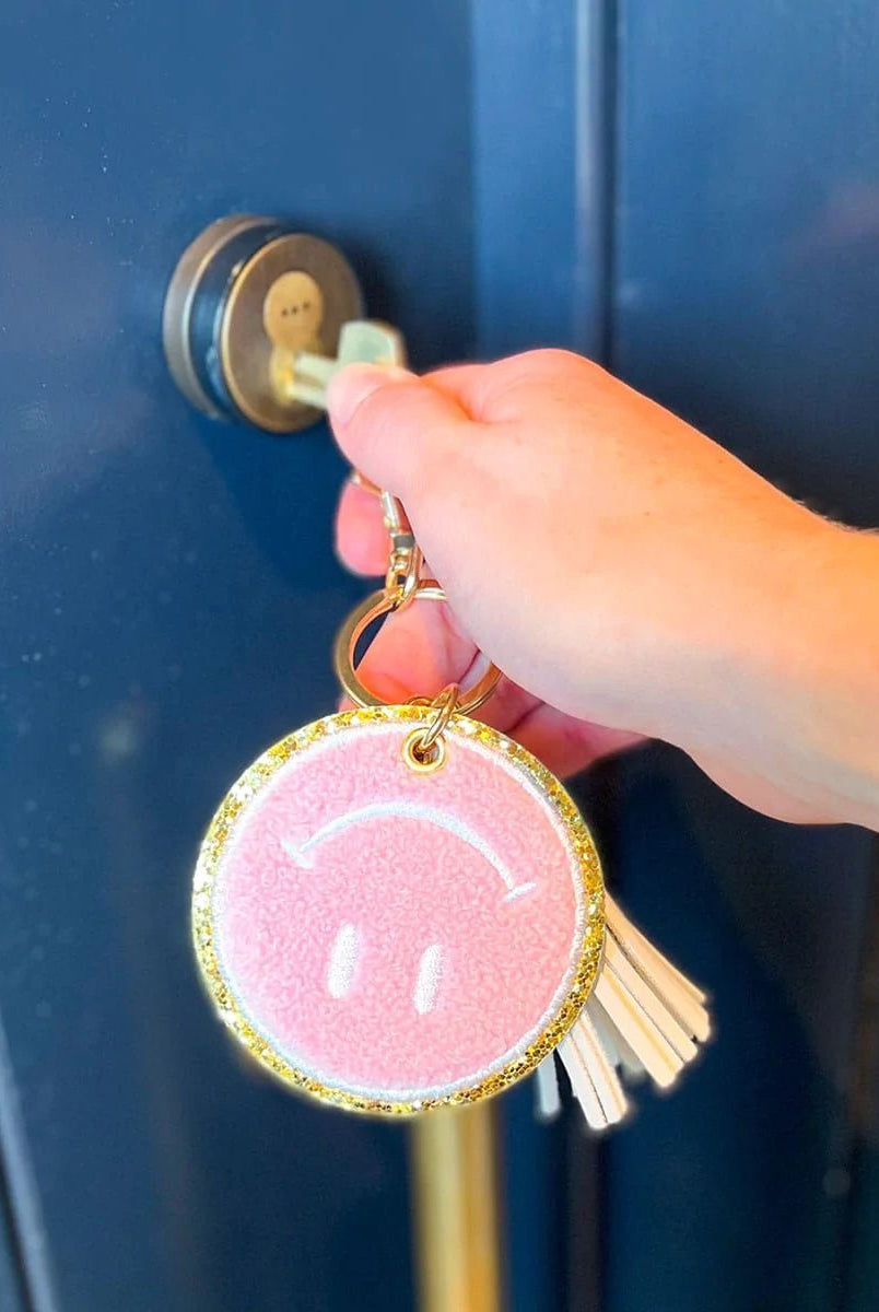 Packed Party Keep Cozy Smiley Keychain by Packed Party – Keyring – Pink | Spoiled Brat UK