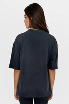 Person wearing a black t-shirt on a white background