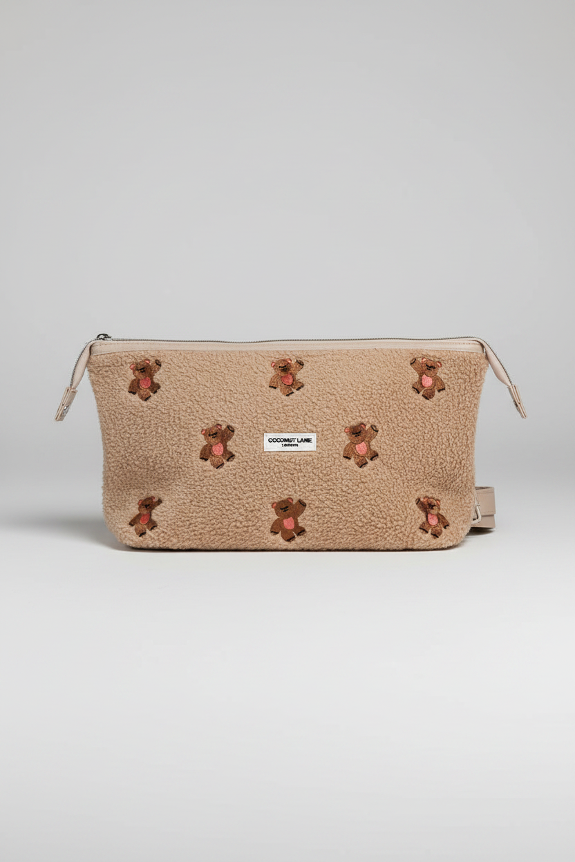 Beige pouch with teddy bear appliqués on a white background