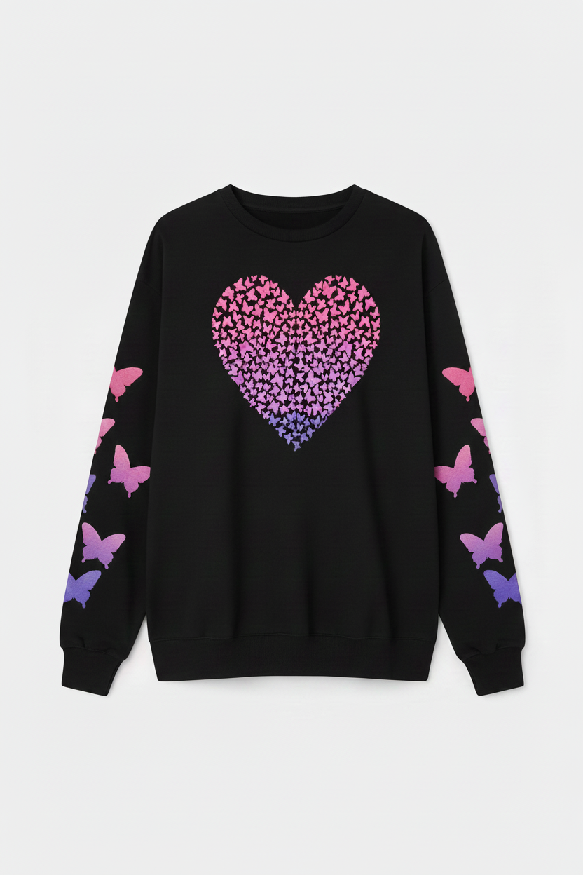 Woman wearing a black sweater with a pink and purple heart design on a white background