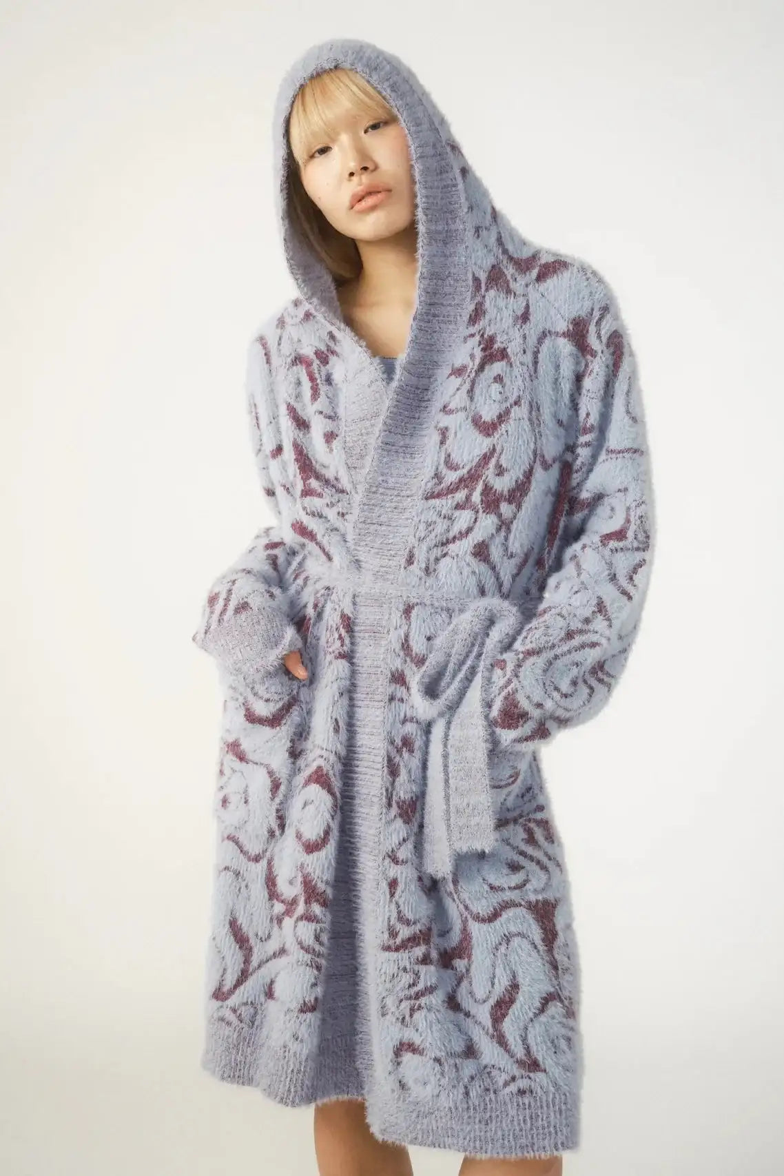 Person wearing a patterned robe on a white background