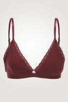 Red bra with lace details on a light gray background