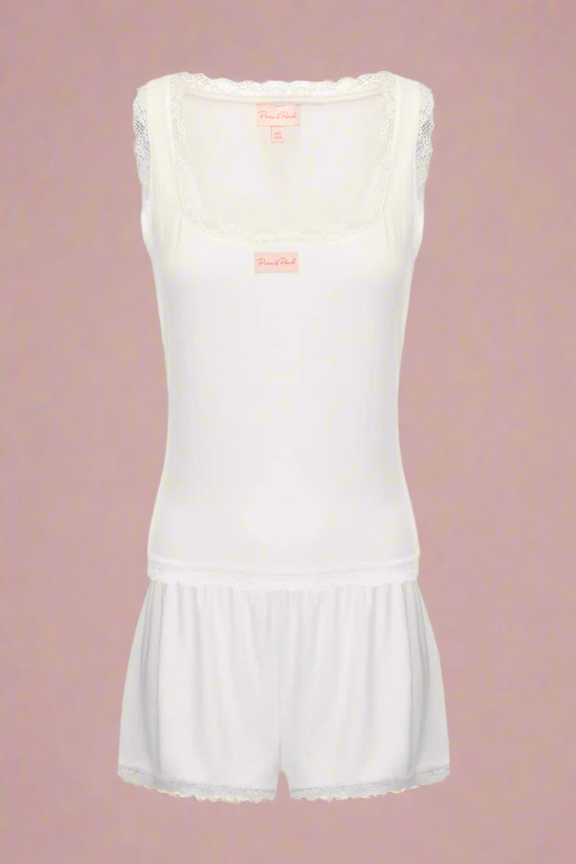 White sleeveless top and shorts set on a light gray background