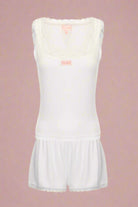 White sleeveless top and shorts set on a light gray background