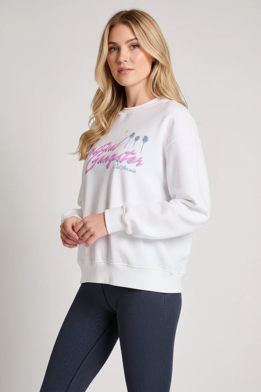 Woman wearing a white sweatshirt with pink text on a plain background