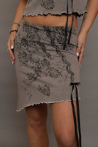 Shop Daisy Street Daisy Street Asymmetrical Skirt with Print & Bow Detail Mini Skirt for women – premium loungewear and festival fashion at Spoiled Brat