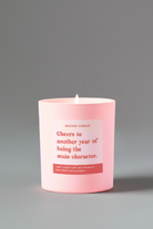 Pink candle with a message on a gray background