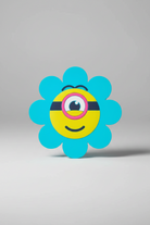 Flower-shaped object with a yellow center and blue petals on a gray background