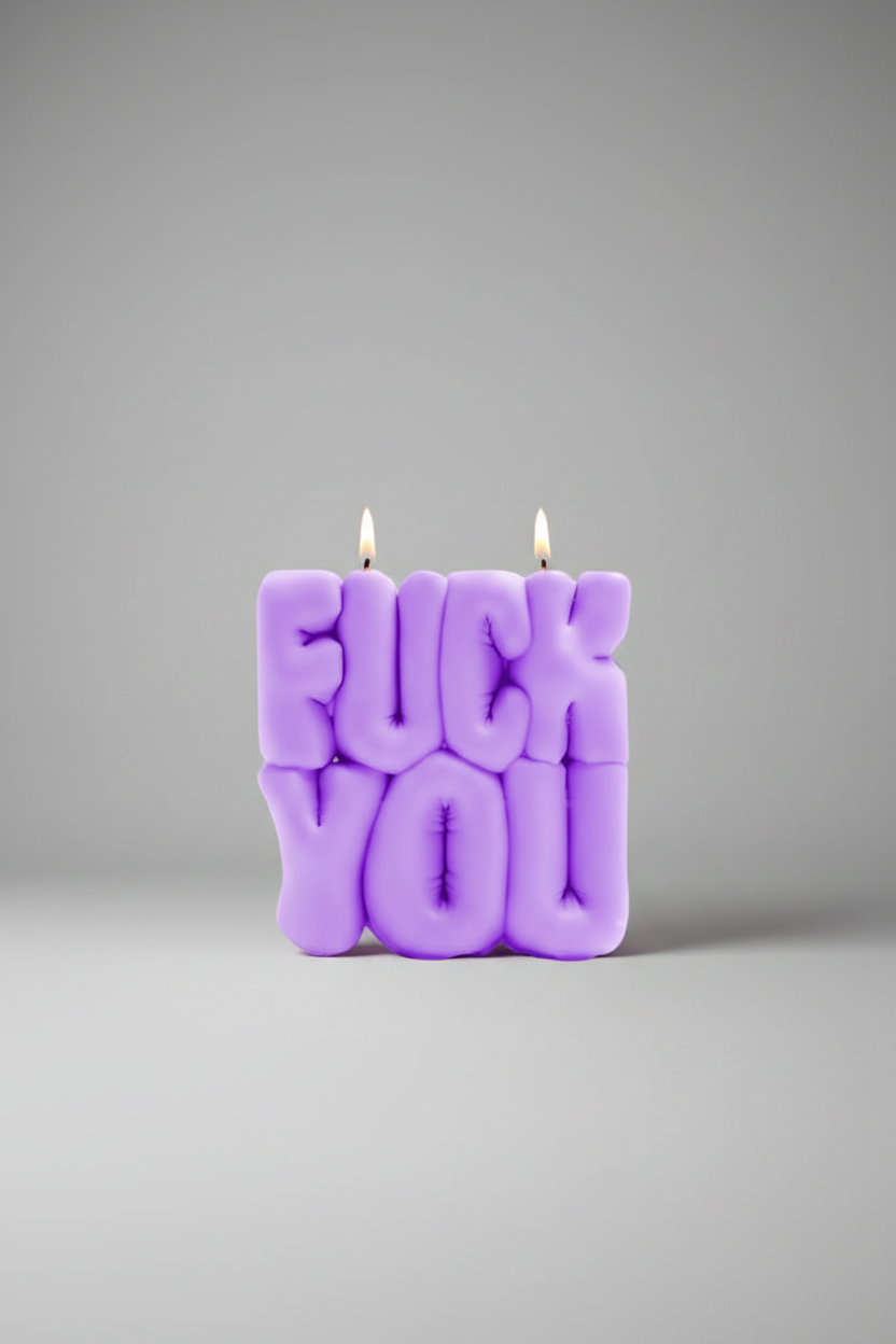Purple candle with 'FUCK YOU' text on a gray background