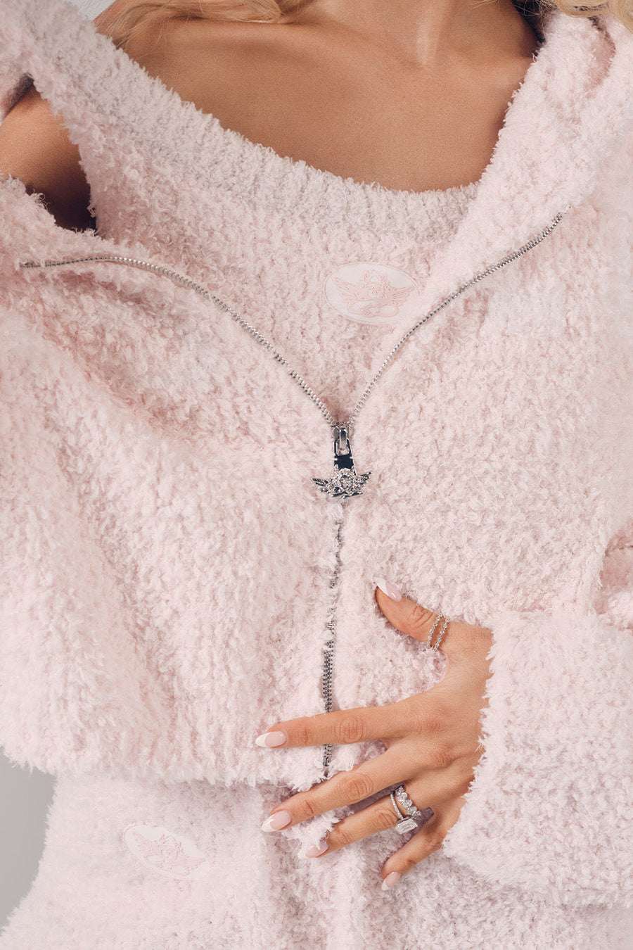 Close-up of a person wearing a fluffy white coat with a blurred background